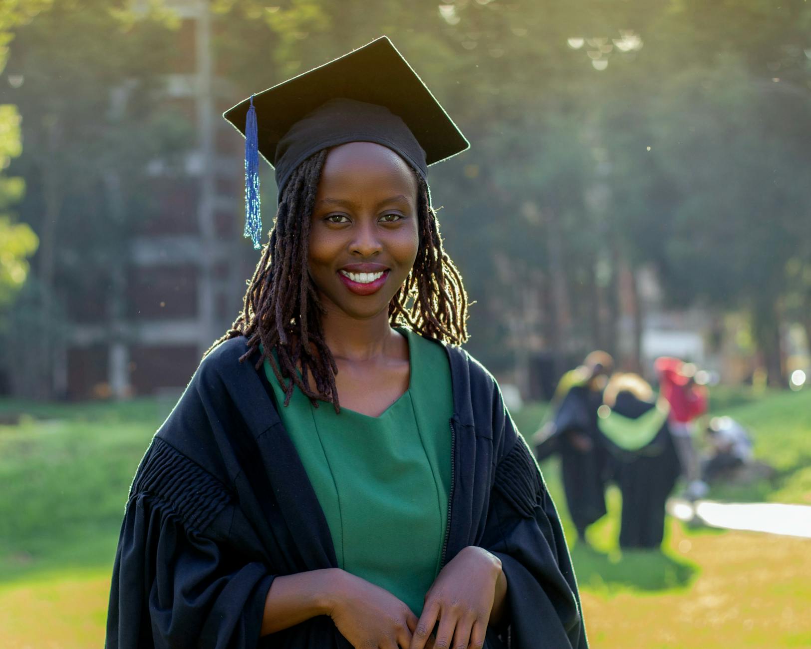 portrait of woman wearing graduation gown and cap