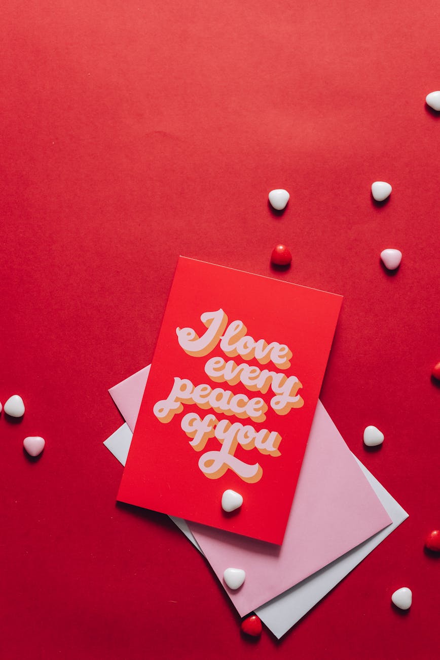 love card with heart shape materials on red surface